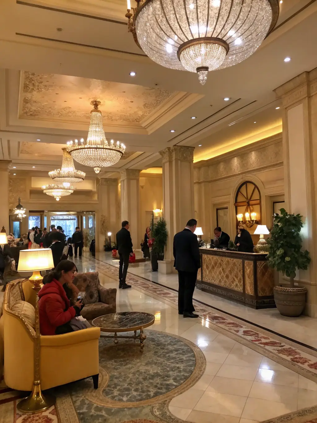A clean and inviting image of a boutique hotel lobby, with guests checking in. The hotel's Google Business Profile is visible on a digital display behind the reception desk.
